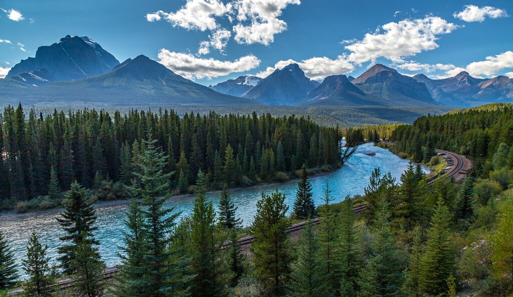 Relish the scenic views like the Rockies, Bow River, and forest (pictured) from your Jasper-Toronto railcar