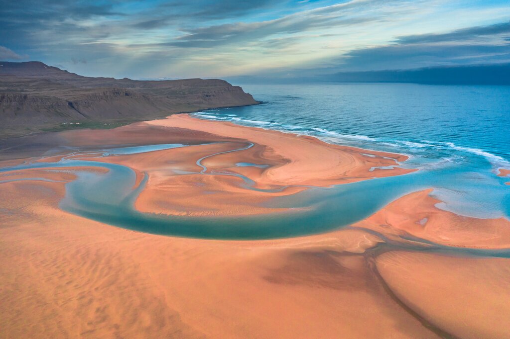 Walk along the red sands of Raudasandur