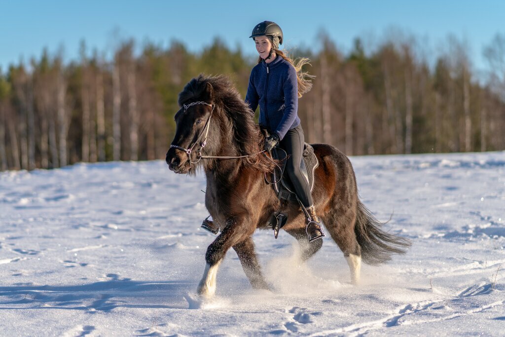 Young girl riding Icelandic horse