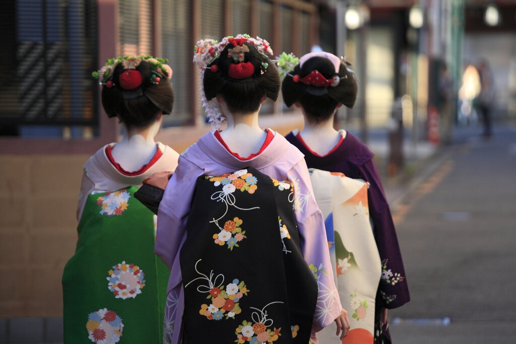 Kyoto, Japan, geisha in traditional kimono walking in Gion Kyoto at night.