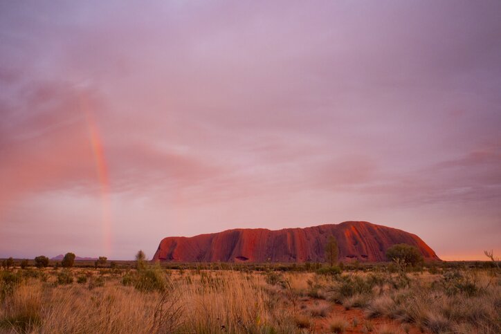 A rainbow over Uluru in Australia's Outback