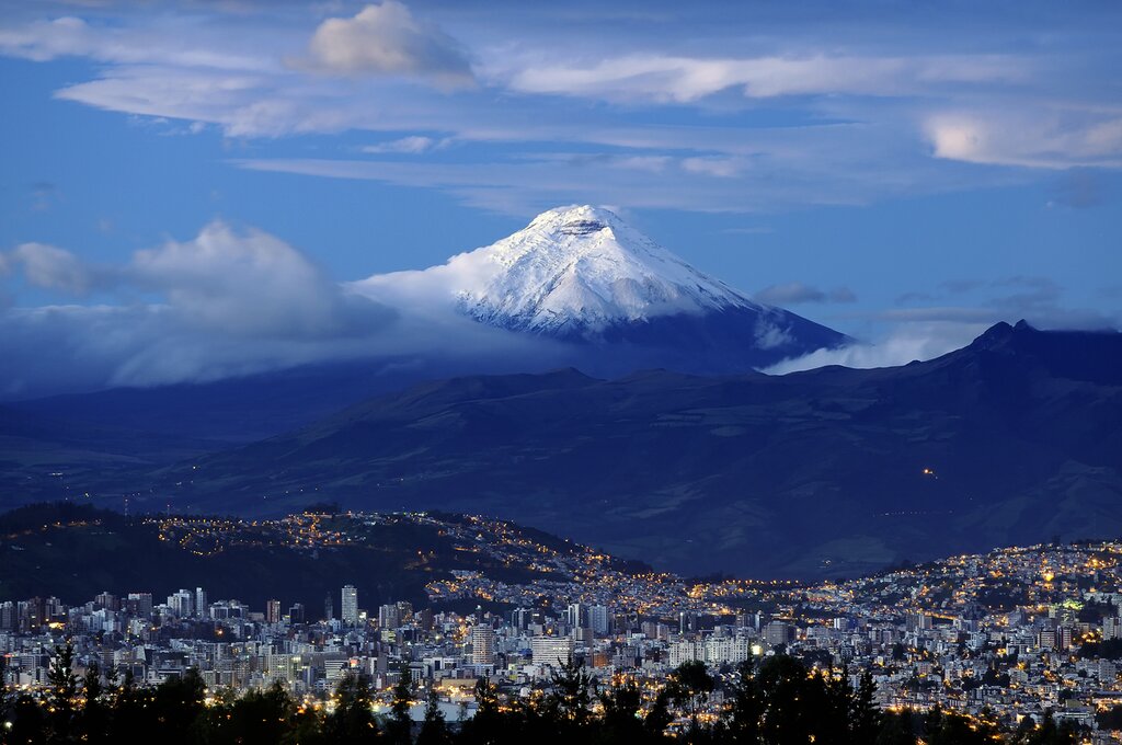 Cotopaxi Volcano towers over Quito, Ecuador, at dusk