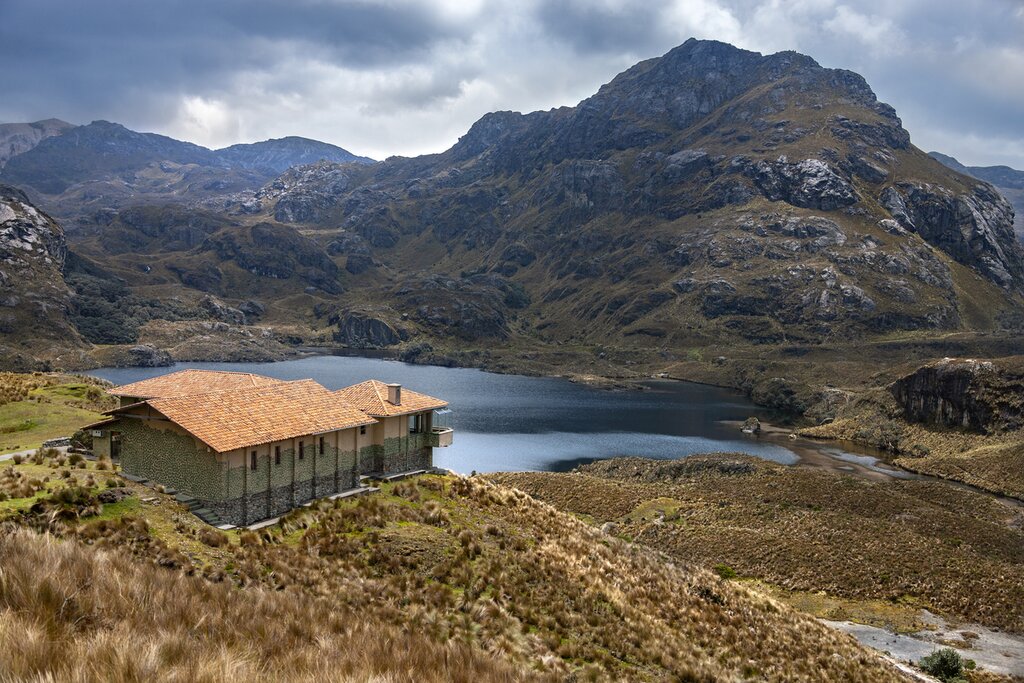 A stone building on the shore of a lake in Cajas National Park