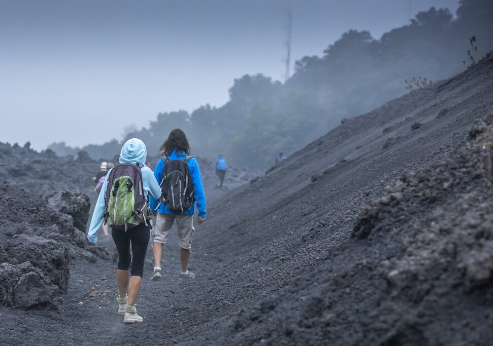 A hiker on the lava field of Pacaya Volcano