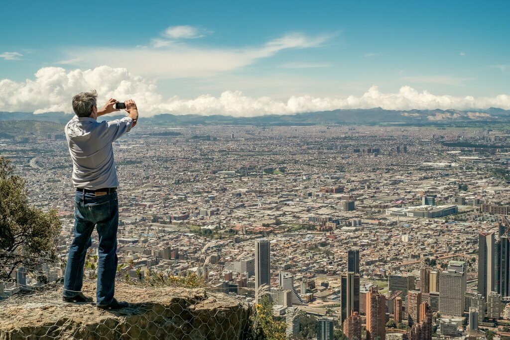 A man looks out over Bogotá from Cerro Monserrate
