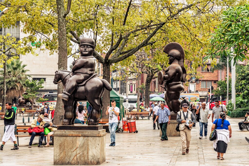 Tourists walking by Botero sculptures located at Botero Plaza in Medellin,