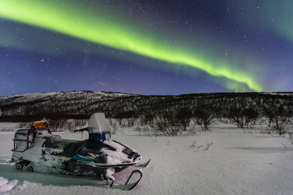 Snowmobile under the northern lights