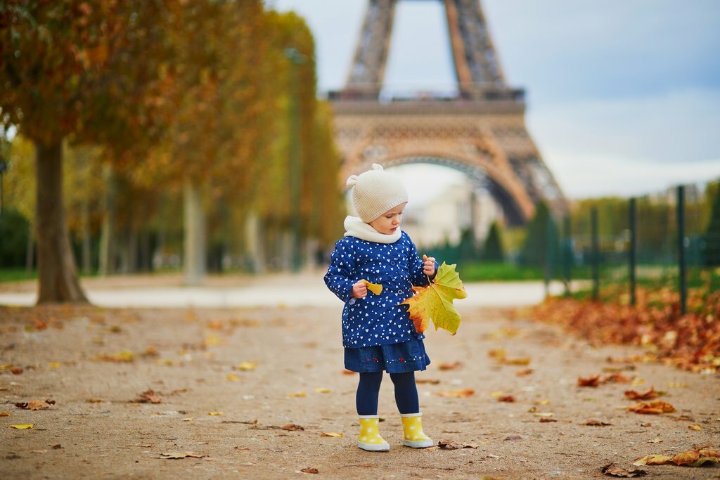 Young child enjoying autumn in Paris