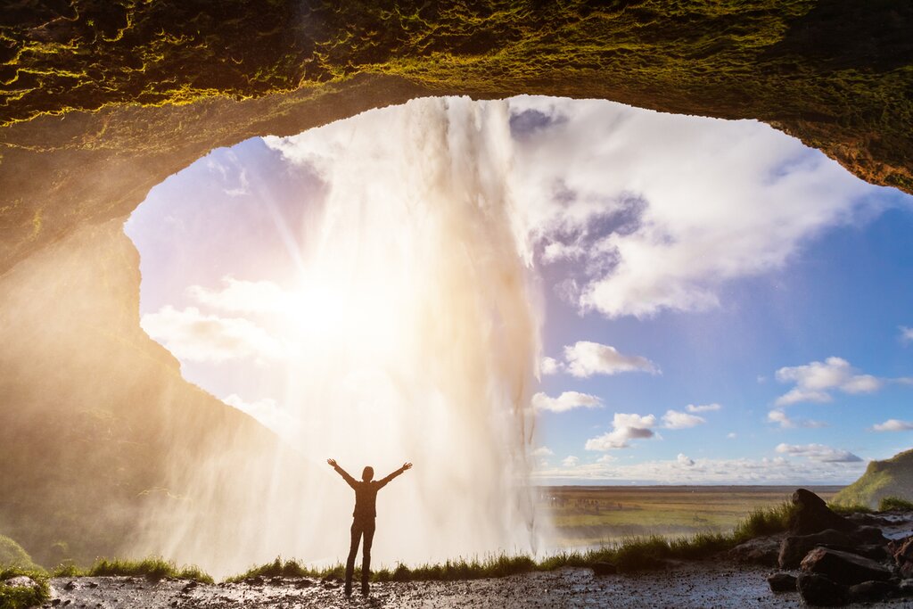 Stand behind the famous Seljalandfoss waterfall in Iceland's captivating south
