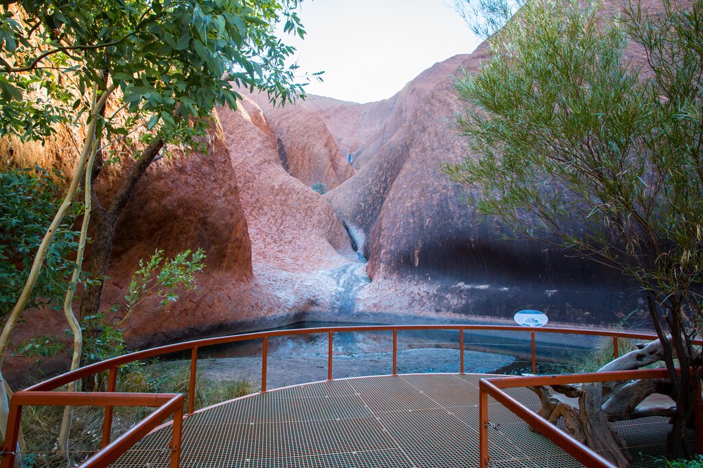 Mutitjulu Waterhole on the Kuniya walk at Uluru on a clear winter's afternoon in the Northern Territory, Australia