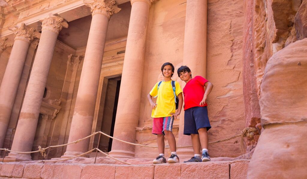 Travellers visiting Petra in Jordan during summer trip