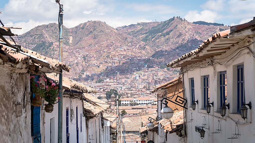 Narrow streets in Cusco frame the dry hills