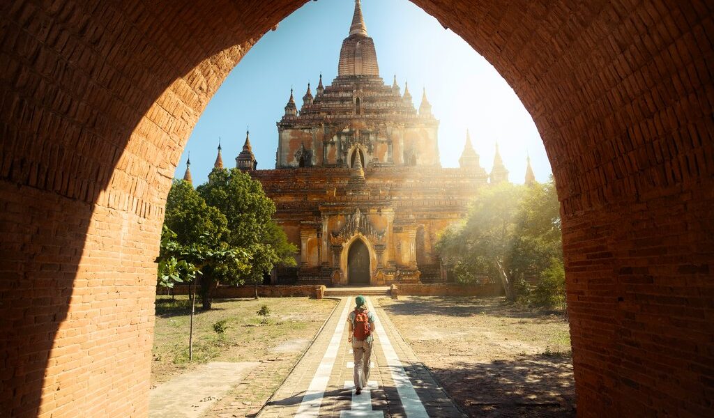 Traveler walking along the road to the Htilominlo temple in Bagan Myanmar