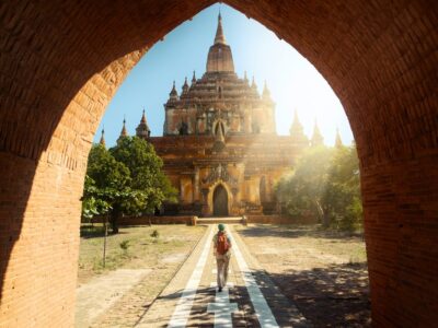 Traveler walking along the road to the Htilominlo temple in Bagan Myanmar