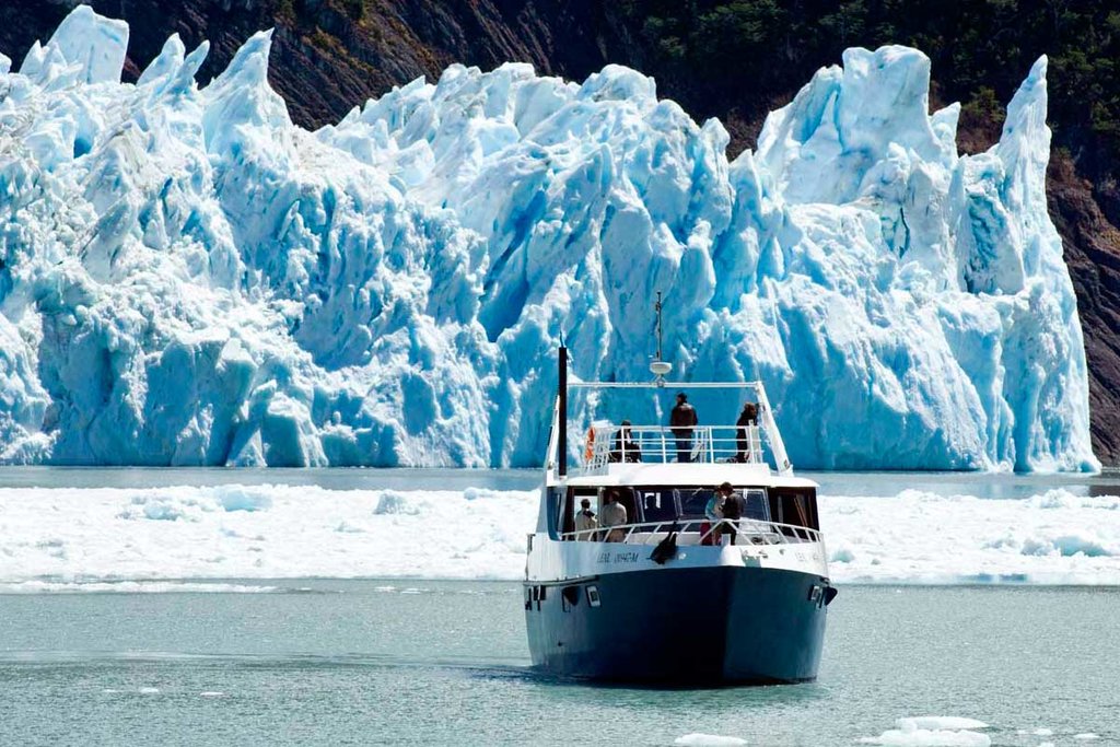 Sail under the towering ice walls of Perito Moreno Glacier.