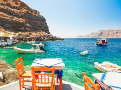 Cafe On The Sea Coast In The Port Of Santorini Island, Greece.