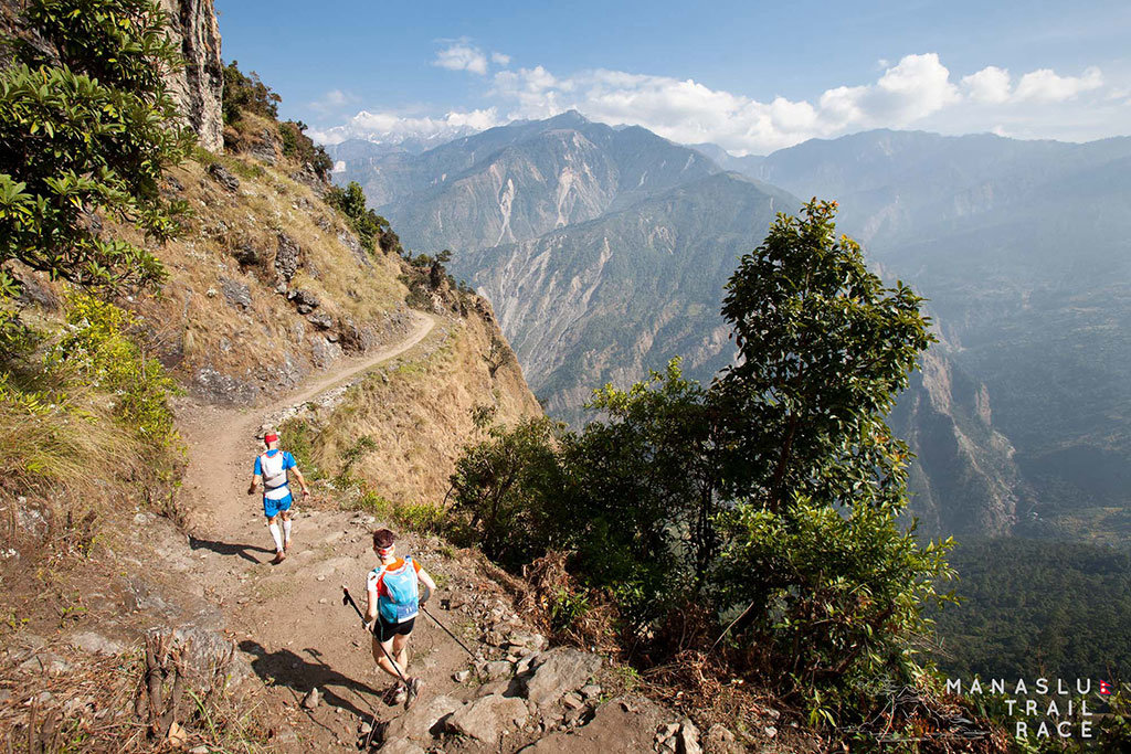 two runners on a trail