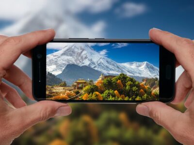 Travel concept. Tourist making photo of Himalayas mountain landscape. Buddhist monastery and Manaslu