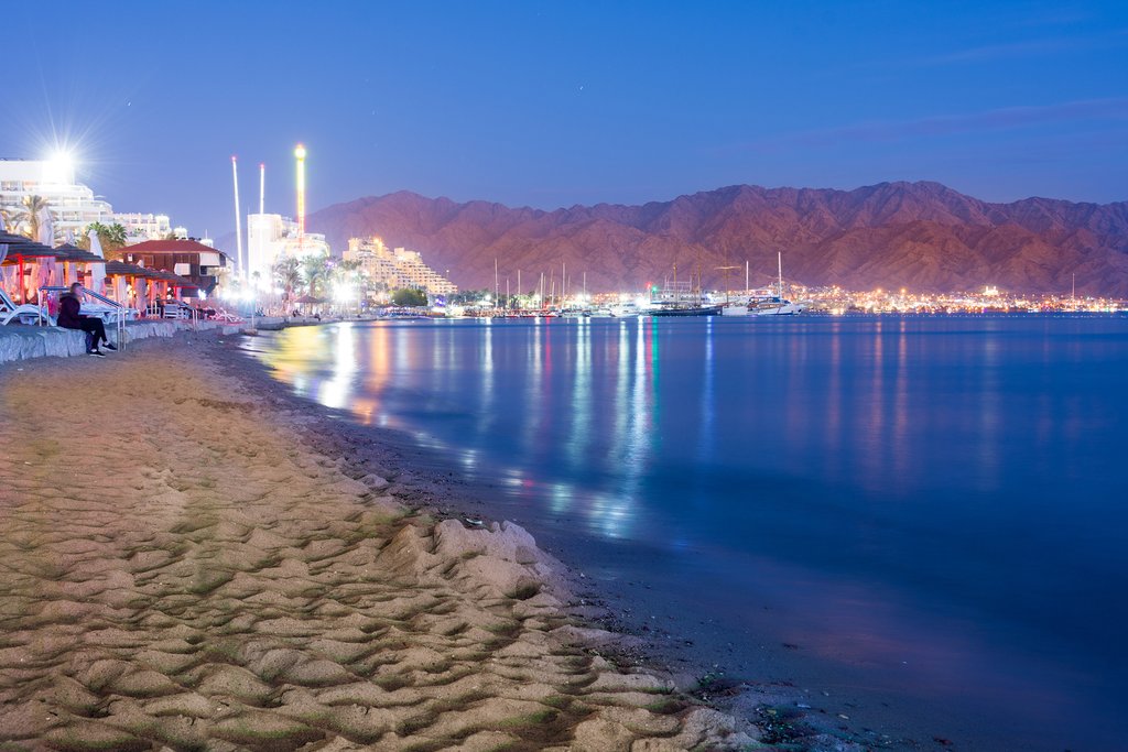 Sunset over the twin cities of Eilat Israel and Aqaba Jordan, with the Aqaba Mountains in the background 