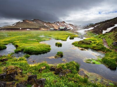 Small river and fresh blooming flowers near thermal springs in L