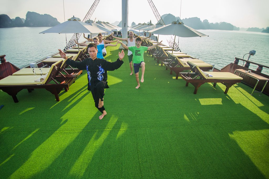 Partake in morning exercise or a swim at the beach in Ha Long Bay