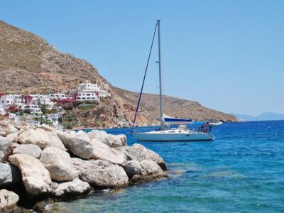 TILOS, GREECE - JUNE 12, 2018: A yacht enters Livadia harbour on