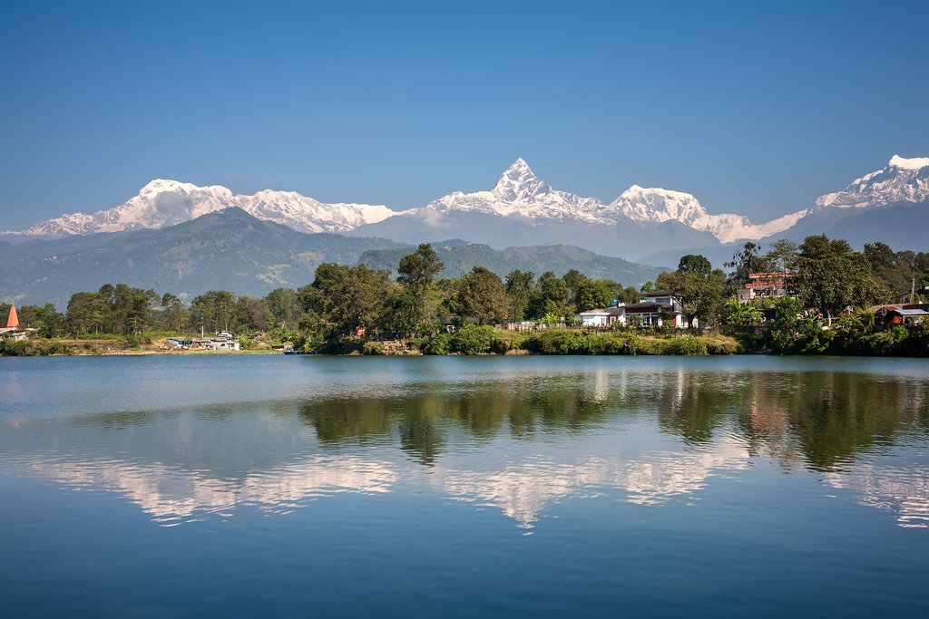The Annapurna mountain range reflects in Lake Phewa, Pokhara