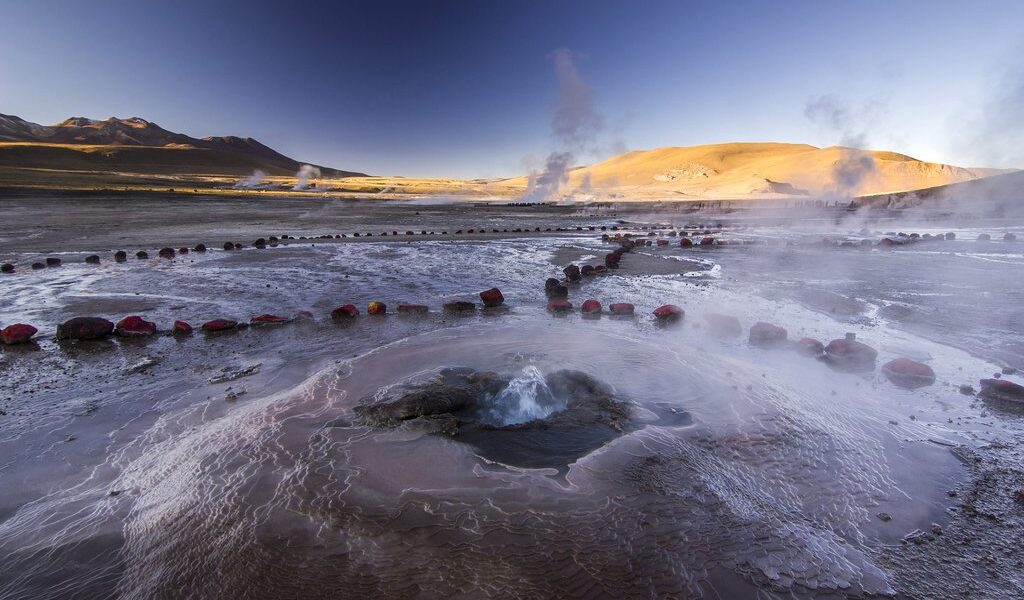 geyser field tatio with water surface at sunrise in atacama desert, chile