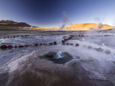 geyser field tatio with water surface at sunrise in atacama desert, chile