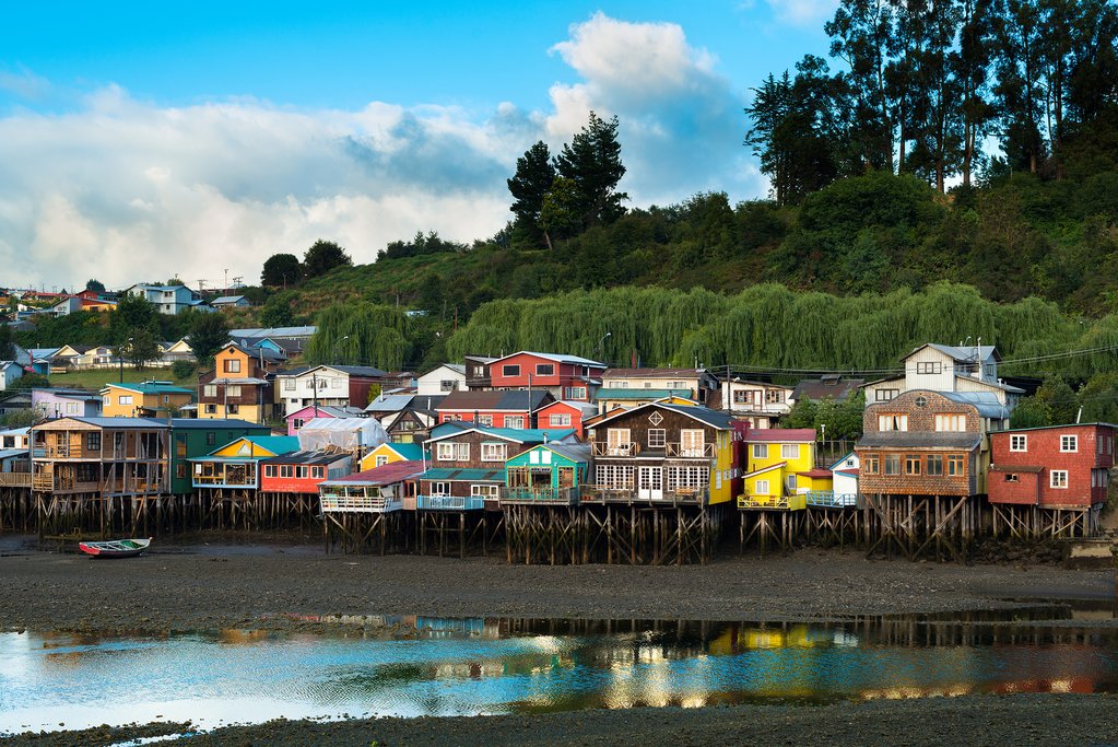 The colorful palafito houses line the waterfront of the Chiloé village of Castro