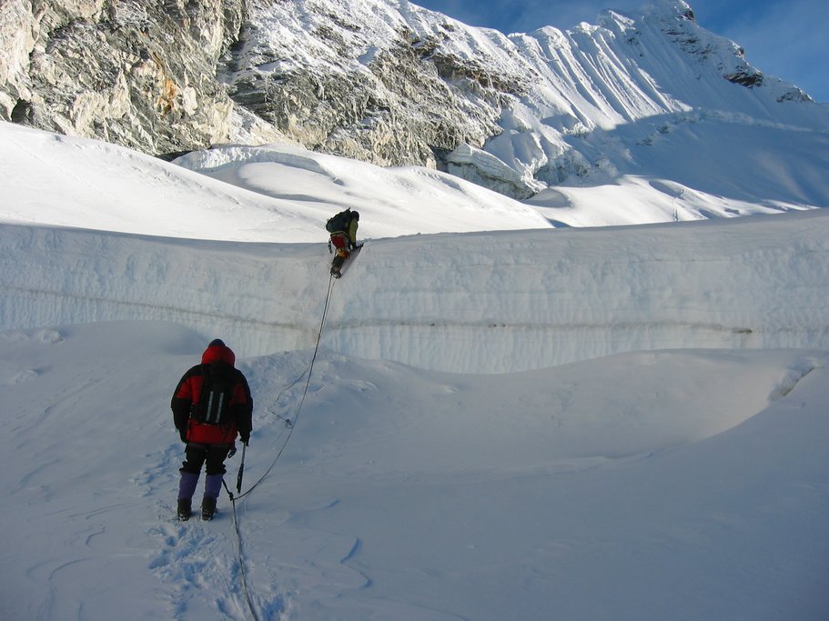 Crossing a large crevasse, Island Peak in the background