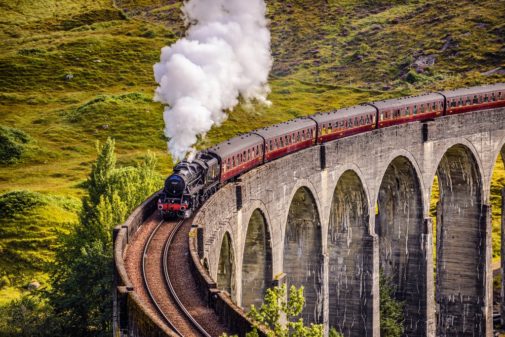 The Jacobite Express crosses the Glenfinnan Viaduct on its way to the coast.