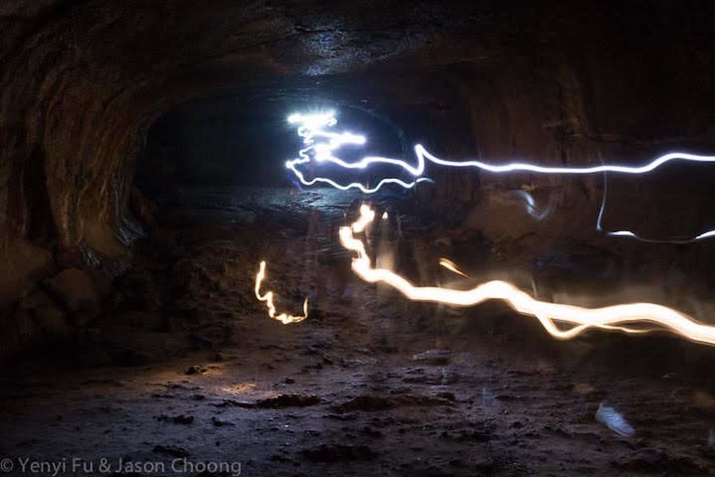 Exploring the lave tube with flashlight (Photo courtesy of @yenyifu)