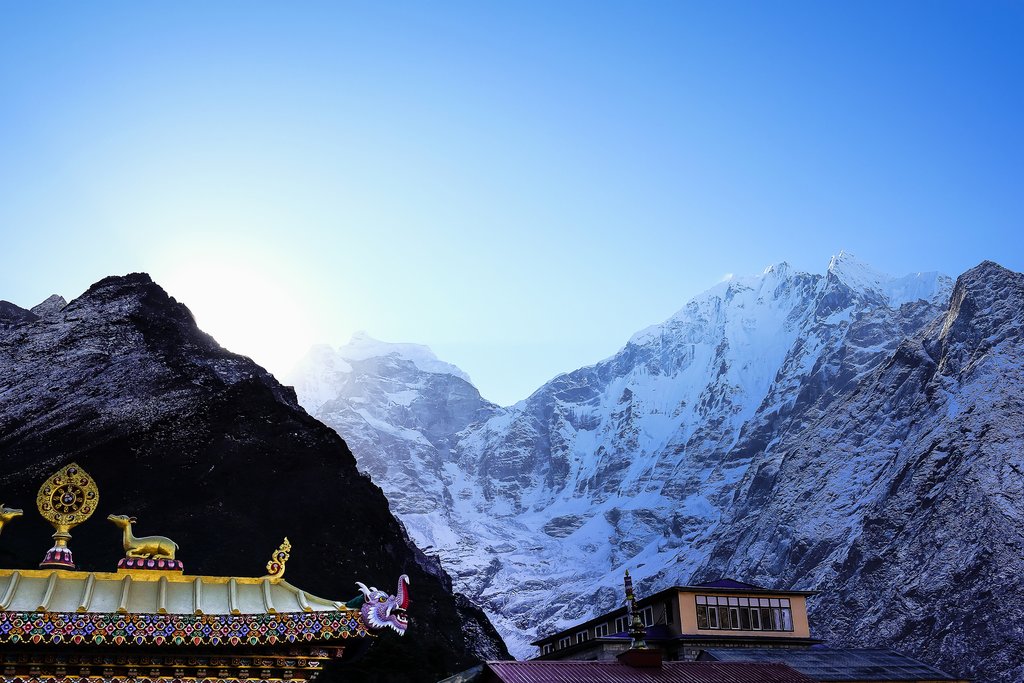 The sun dipping behind the peaks in Tengboche