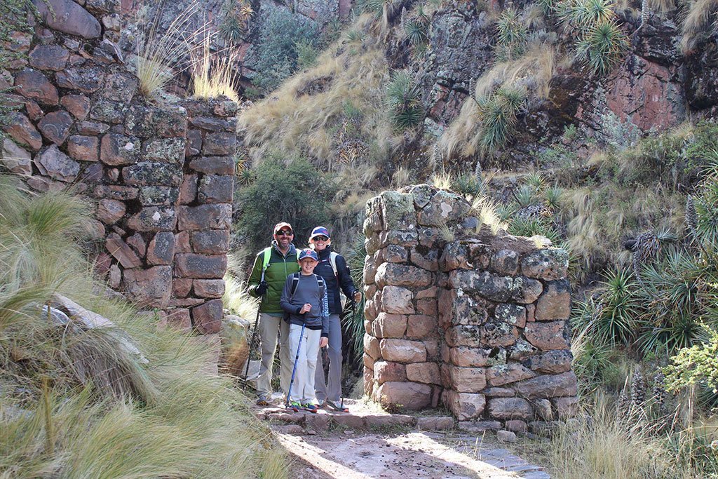 Family walking in Inca ruins