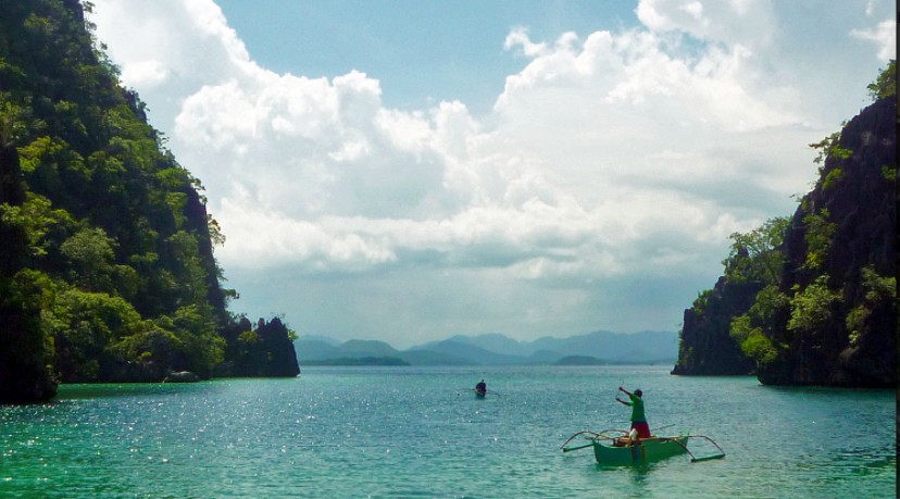 A local fishermen between karst cliffs