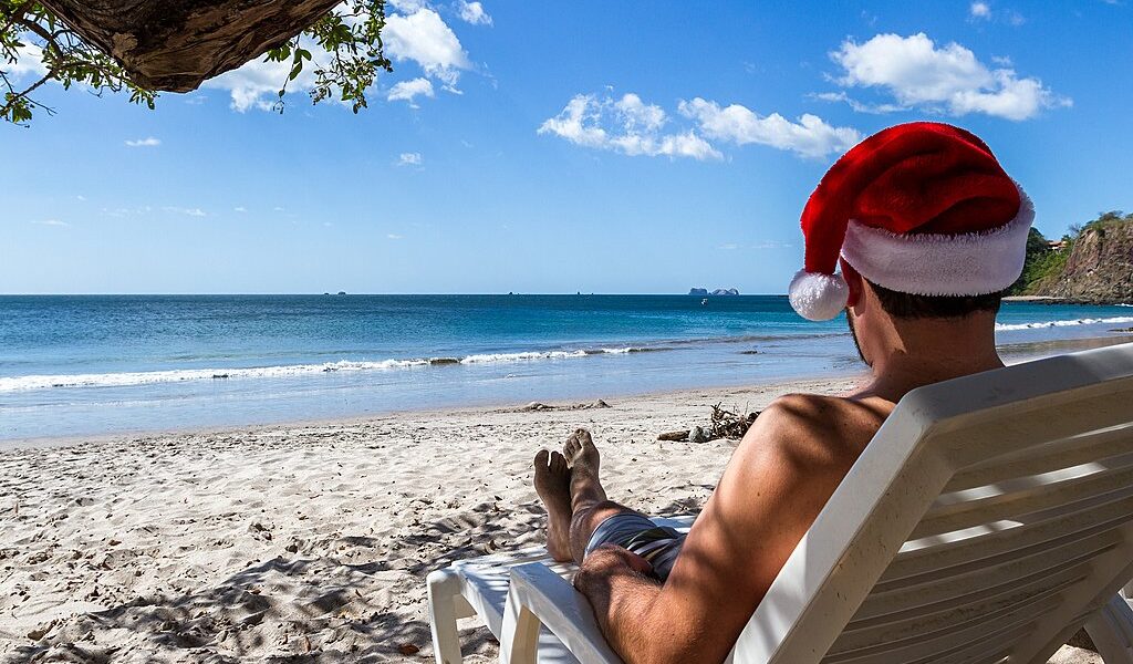 Holiday Concept With A Man Wearing A Santa Hat Relaxing On A Lou