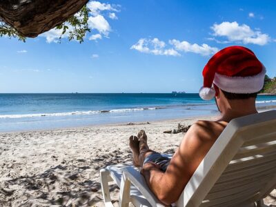 Holiday Concept With A Man Wearing A Santa Hat Relaxing On A Lou