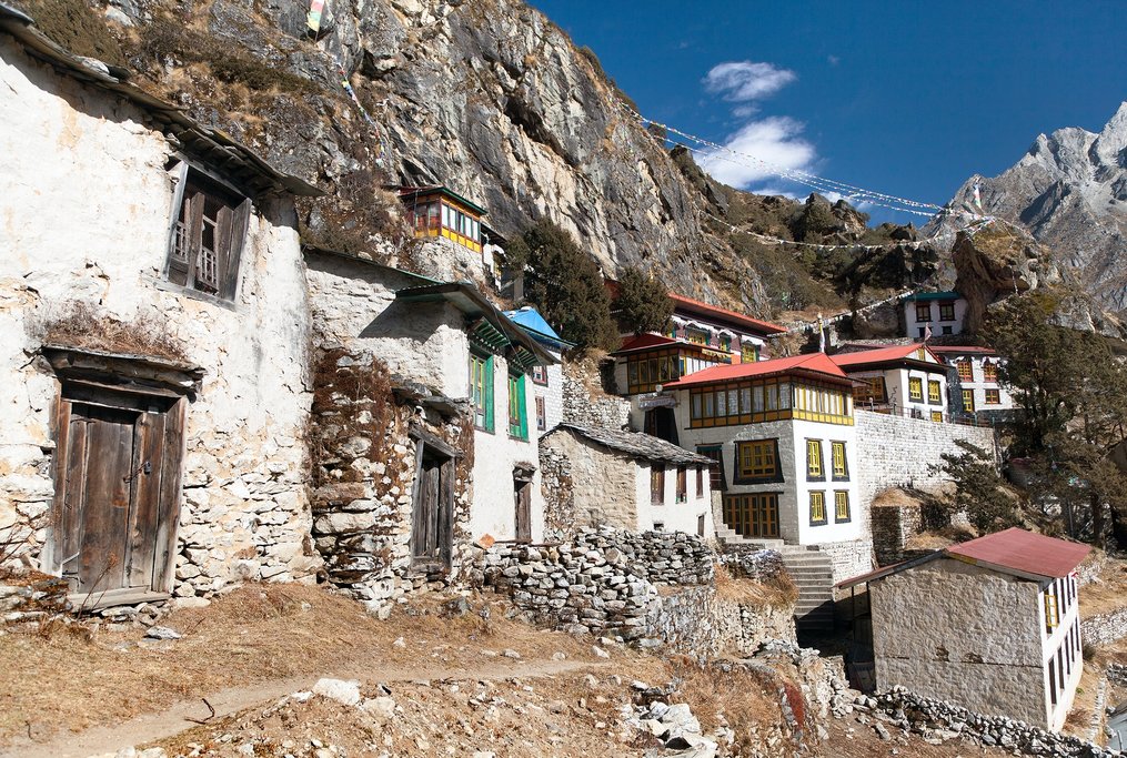 Thame gompa with prayer flags and buddhist symbols - monastery in Khumbu valley