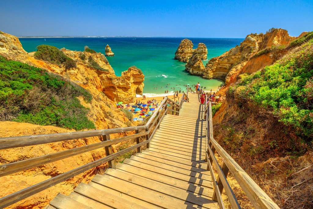 Take the wooden walkway to scenic Praia do Camilo in Lagos