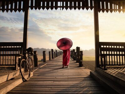 Monk walk on the wooded bridge U Bein Bridge Mandalay Myanmar