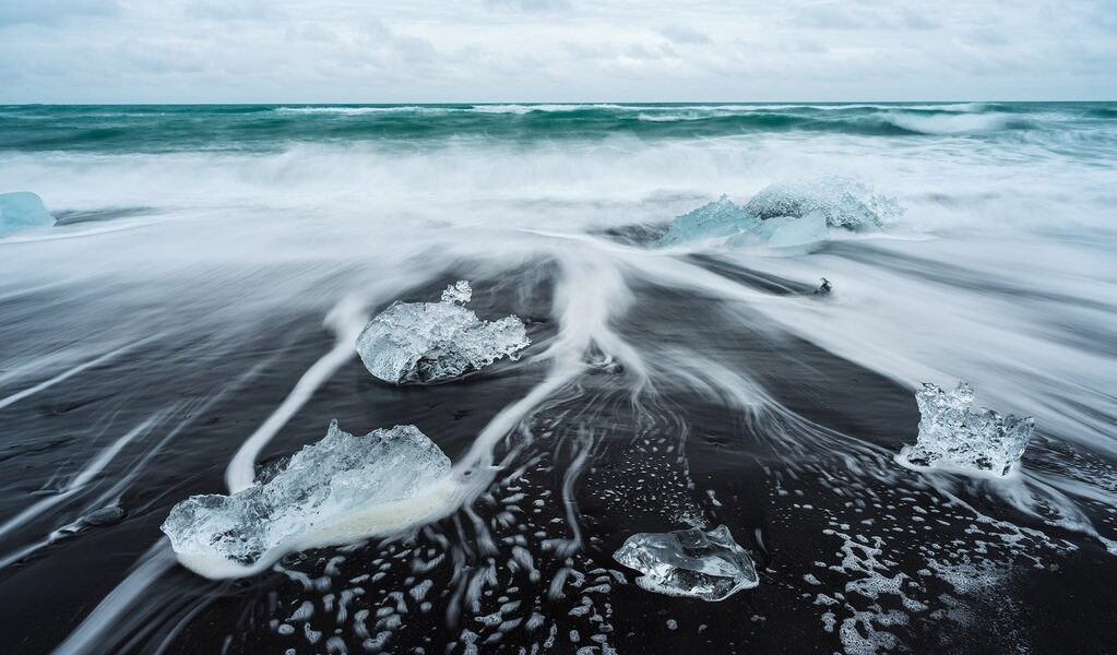 Icy beach in Iceland, Europe. Ice on the black volcanic sand on