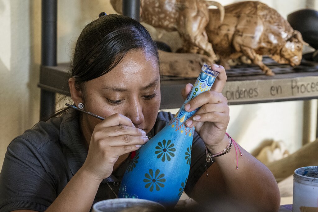 An artist paints the alebrije