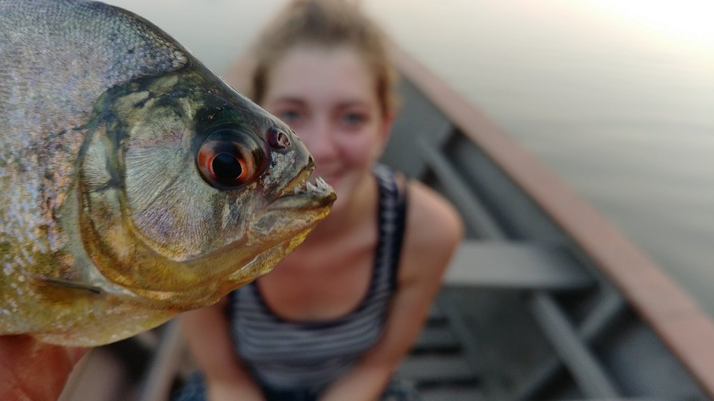 One of our guests with the piranha she'll be eating for dinner!
