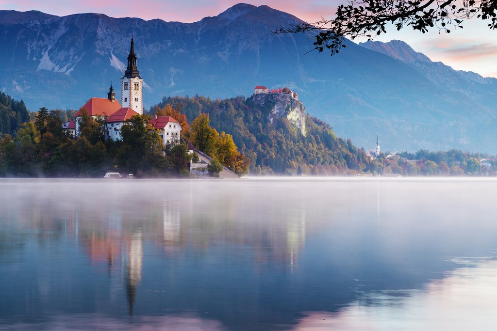 The old church and castle rising above Lake Bled