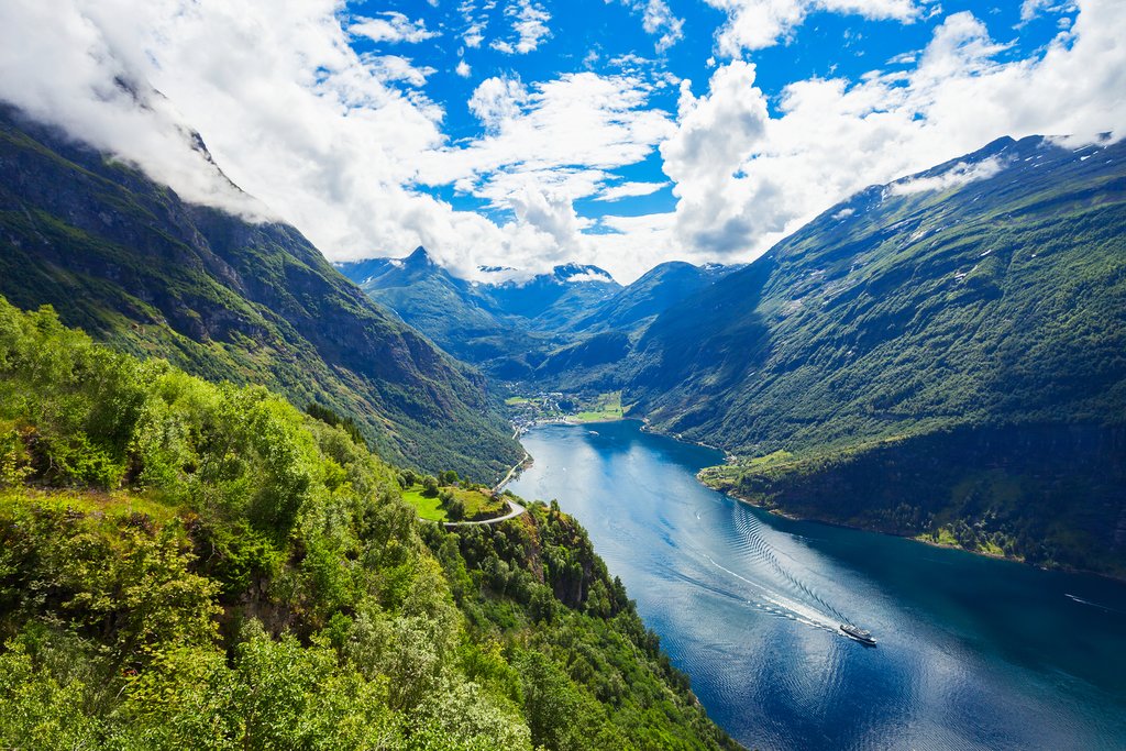 Travel through the deep-blue water of the Geirangerfjord.