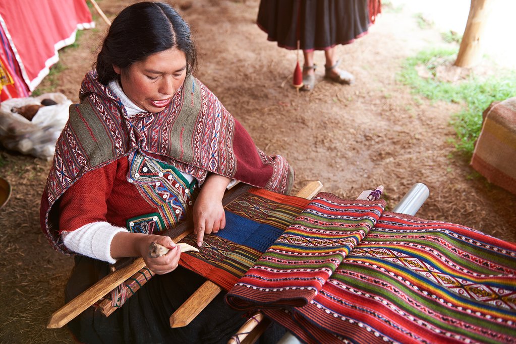 A Peruvian woman weaving on a traditional handloom