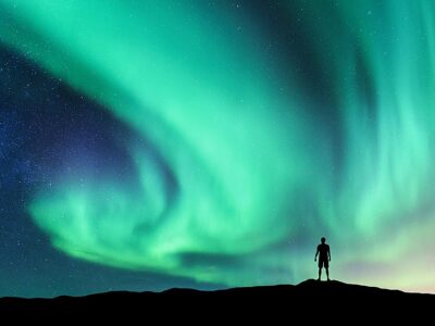 Aurora Borealis And Silhouette Of Standing Man. Lofoten Islands,