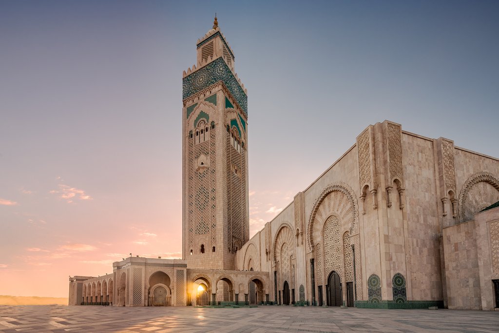 The morning sun peeks through the impressive Hassan II Mosque