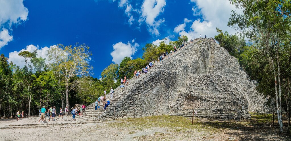 Tourists climbing the pyramid stairs
